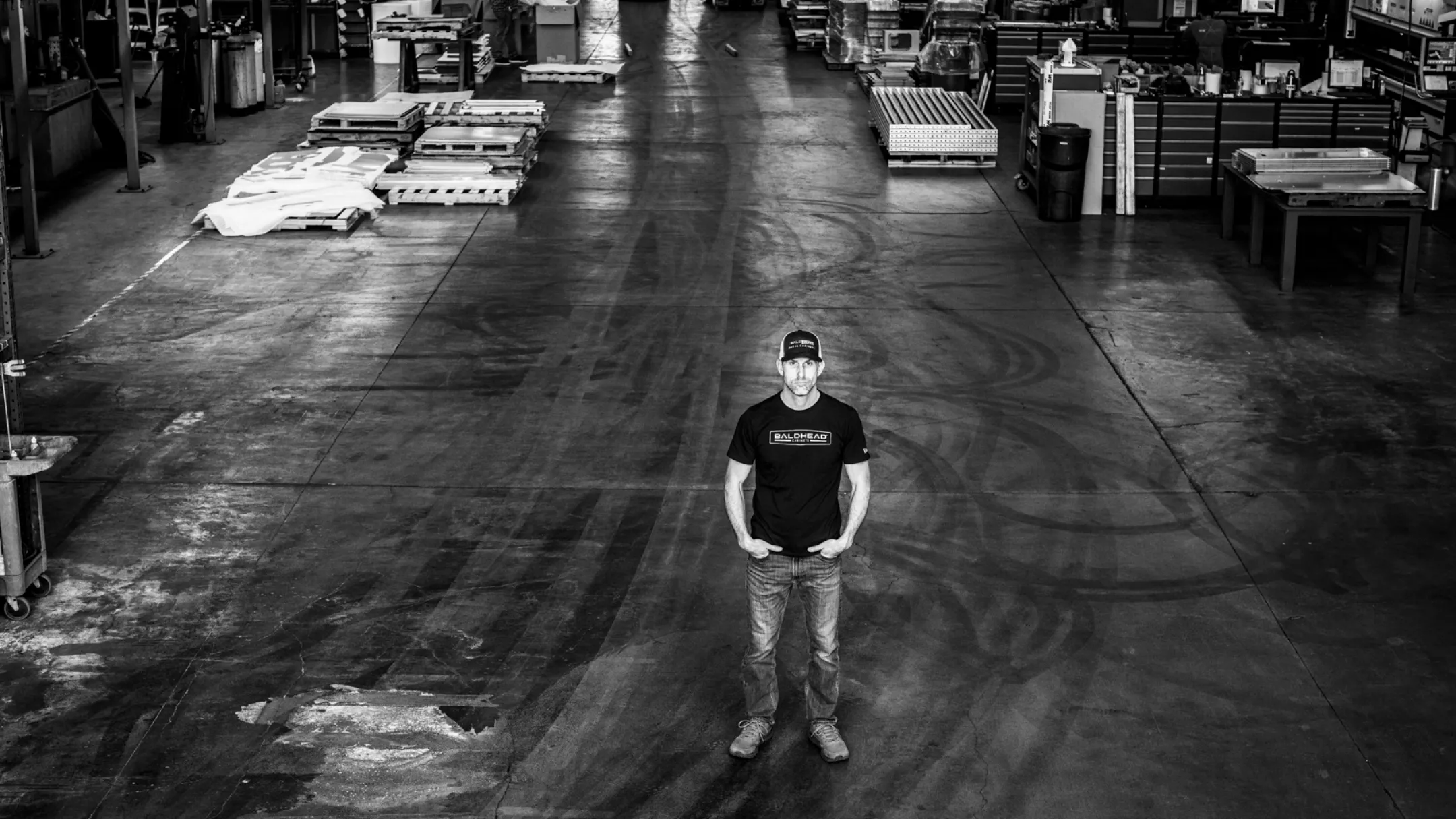 A craftsman stands in the heart of our workshop, symbolizing dedication at Baldhead Cabinets.